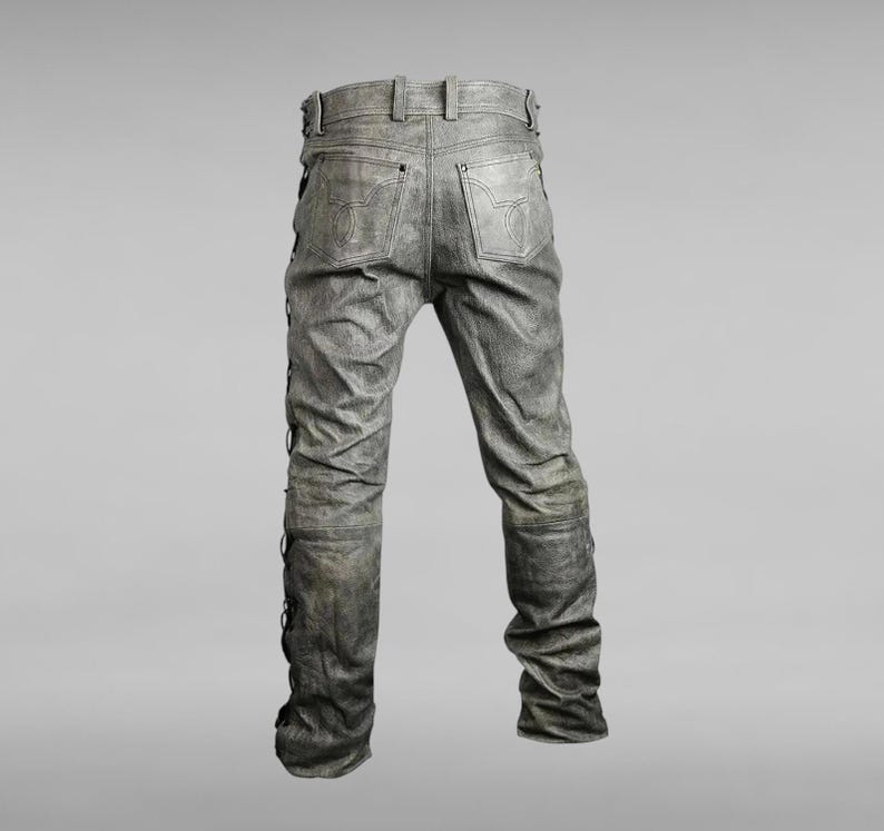 May include: Gray denim jeans with a distressed look and black lacing down the sides of the legs.