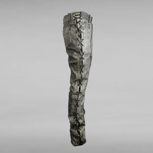 May include: Gray denim pants with black laces running up the side seams.
