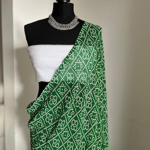 Green Bhandani saree with white sequinned blouse. Soft to drape and easy to style
