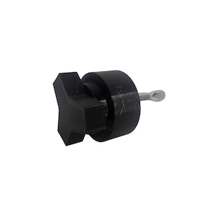 May include: A black, star-shaped bottle stopper with a cylindrical body and a silver metal screw. The stopper is made of a solid, matte material and is designed to fit into a bottle.