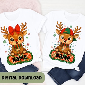 May include: Two white t-shirts with matching Christmas reindeer graphics. One reindeer wears a red bow, the other a green and red cap. Both have a scarf, Christmas lights, and a name on a plaid background. The words "Digital Download" are at the bottom.