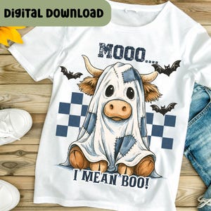 May include: White t-shirt with a Halloween-themed graphic. The design features a cow dressed as a ghost with the text "MOOO... I MEAN BOO!" and bat silhouettes. A digital download label is in the top left corner.