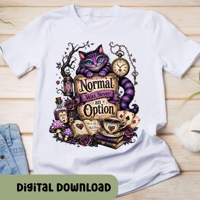 May include: A white t-shirt featuring a graphic of a purple striped cat with a wide grin, a pocket watch, a lantern, playing cards, a teacup, and an open book. The text reads, "Normal Was Never an Option" and "We're All Mad Here."