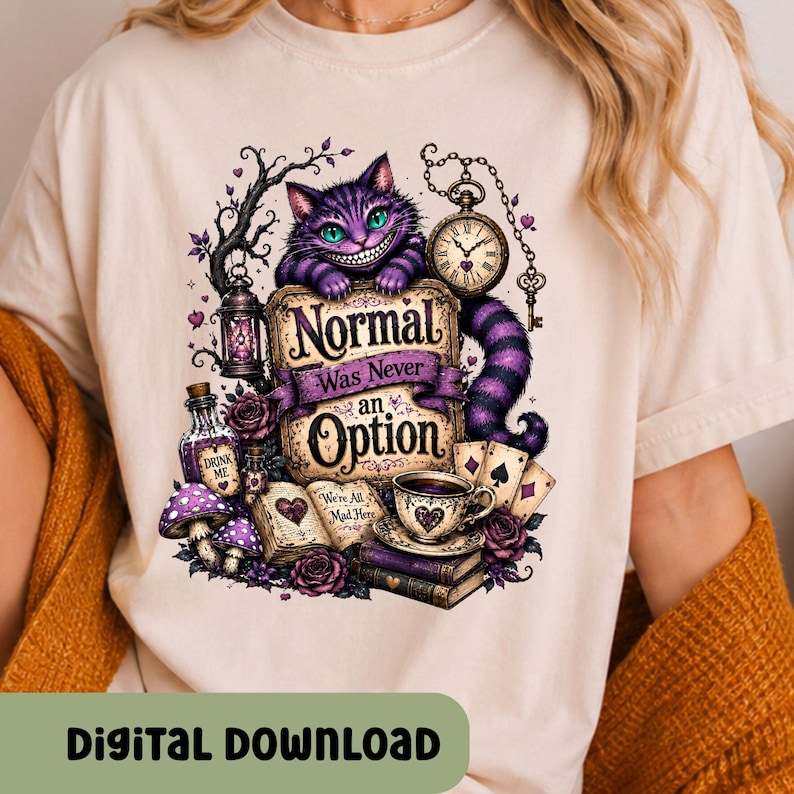 May include: A cream-colored t-shirt featuring a graphic of a purple striped cat with a wide grin, a pocket watch, playing cards, a teacup, a book, and mushrooms. The text reads "Normal Was Never an Option", "Drink Me", and "We're All Mad Here".