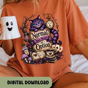May include: An orange t-shirt featuring a graphic of a purple striped cat, a pocket watch, a teacup, playing cards, and an open book with the text Normal Was Never an Option and We're All Mad Here. A white ghost-shaped mug is held to the side.