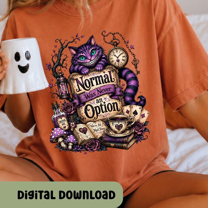 May include: An orange t-shirt featuring a graphic of a purple striped cat, a pocket watch, a teacup, playing cards, and an open book with the text Normal Was Never an Option and We're All Mad Here. A white ghost-shaped mug is held to the side.