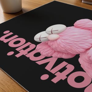 May include: A black surface with the pink word "Motivation" and a pink, plush, cartoon character with white eyes and cross-shaped markings. The character has a pink nose and fluffy pink fur.