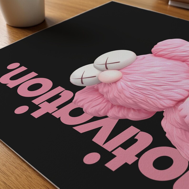 May include: A black surface with the pink word "Motivation" and a pink, plush, cartoon character with white eyes and cross-shaped markings. The character has a pink nose and fluffy pink fur.