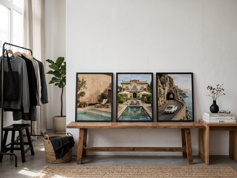 May include: Three rectangular wall art prints in black frames displayed side-by-side. The left print shows a pool by a tan wall, the center print features a villa with a pool, and the right print depicts a white car driving on a coastal road.