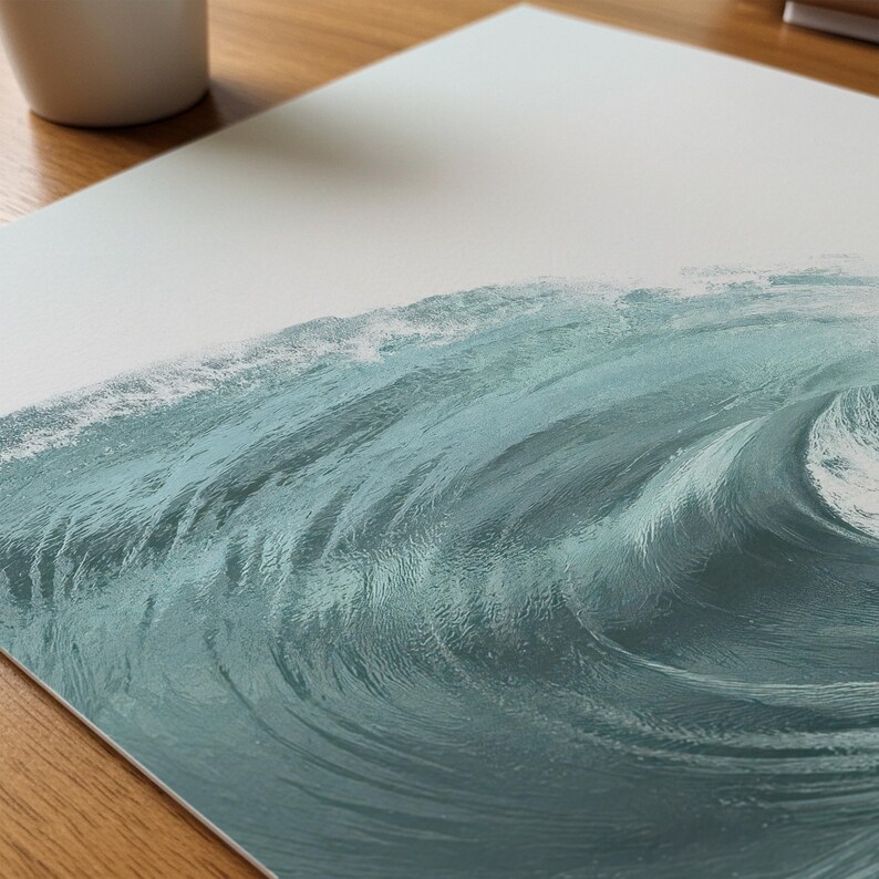 May include: A print of a breaking ocean wave, rendered in shades of teal and turquoise. The artwork captures the dynamic movement of the water, with a cresting wave and foamy white water. The print is on a white background.