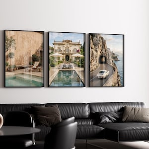 May include: A set of three framed wall art prints displayed in a row. The left print shows a pool by a beige wall, the center print features a grand villa with a pool, and the right print depicts a vintage car driving on a coastal road by cliffs.