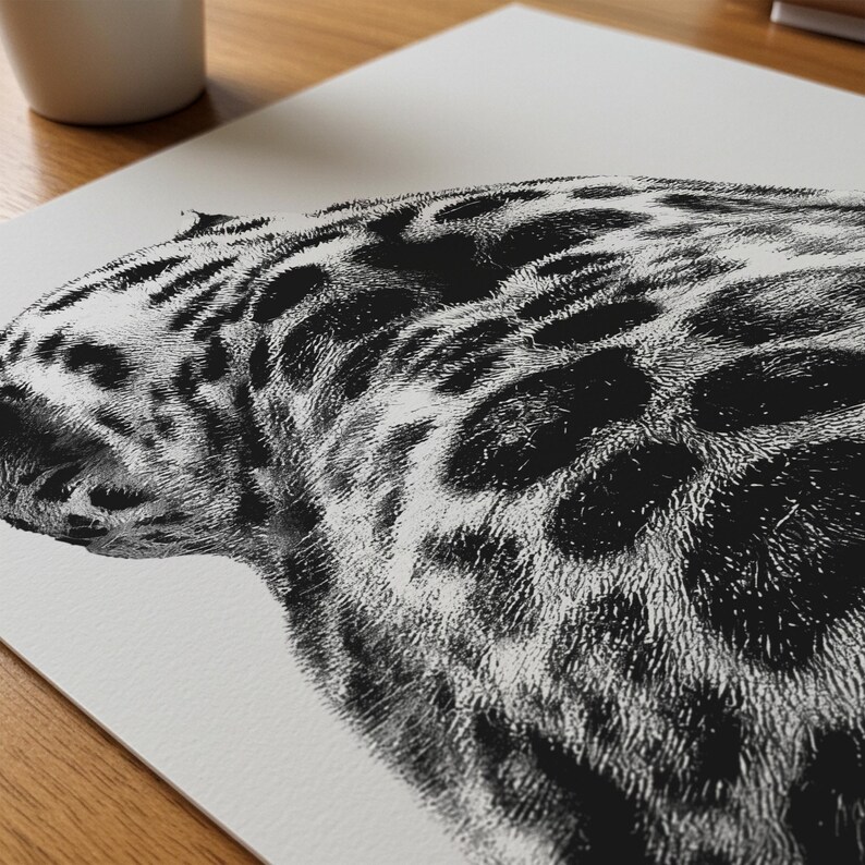 May include: Black and white art print of a jaguar's head and upper body. The illustration features detailed fur texture and distinctive dark spots on a light background. The artwork is a close-up view of the animal's side profile.