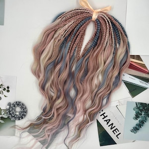 May include: A bundle of pre-stretched synthetic braiding hair in shades of pink, blue, and blonde. The hair is wavy and has a natural look.
