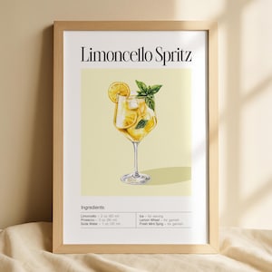 May include: A framed print with a watercolour illustration of a Limoncello Spritz cocktail. The drink is in a stemmed glass, garnished with a lemon wheel and mint sprig. The ingredients are listed below the image: Limoncello, Prosecco, and Soda Water.