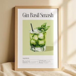 Peut inclure: Une affiche encadrée représentant une illustration à l'aquarelle d'un cocktail Gin Basil Smash. La boisson est dans un verre transparent avec des glaçons, des feuilles de basilic et une paille noire. Le texte "Gin Basil Smash" est en haut, avec les ingrédients en dessous.
