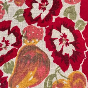 May include: Close-up of a fabric with a repeating pattern of red flowers, strawberries, pears, and cherries. The flowers have white centers and the fruits are in shades of red, yellow, and orange. Green leaves and stems are interspersed throughout the design.
