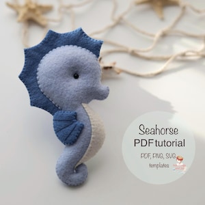 May include: A handmade felt seahorse in shades of blue and white. The seahorse has a detailed fin and a decorative crown. The image includes the text "Seahorse PDF tutorial" and "PDF, PNG, SVG templates".