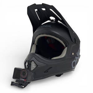 May include: A black O'Neal full-face helmet with a visor and a camera mount. The helmet has a matte finish and a grey interior. An Action 5i camera is attached to the front.