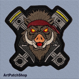 May include: Embroidered patch featuring a fierce, red-eyed wild boar wearing a red bandana and a leather jacket. The boar's head is surrounded by two crossed pistons, each with a silver ring and yellow stripes.