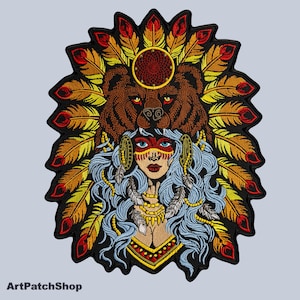 May include: Embroidered patch depicting a Native American woman with blue hair, a bear, and a feathered headdress. The patch has a black border and includes the text "ArtPatchShop" at the bottom.