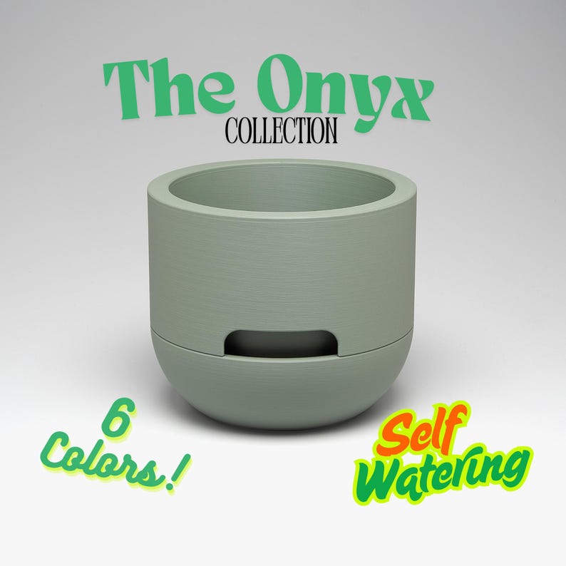 May include: A sage green self-watering planter from The Onyx Collection. The cylindrical pot has a rounded base and a rectangular opening. Text on the image reads "6 Colors!" and "Self Watering."