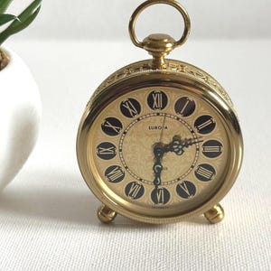 May include: A set of three ceramic mugs with a speckled, matte finish. The mugs are in shades of cream, light gray, and dark gray. Each mug has a simple, minimalist design, perfect for coffee or tea.