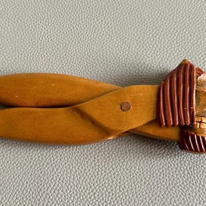 Op de afbeelding: Houten notenkraker met een leeuwenkop ontwerp. De notenkraker is gemaakt van lichtbruin hout met een donkerbruine manen en een gedetailleerd gezicht. De leeuw heeft blauwe ogen en een decoratieve kraag.