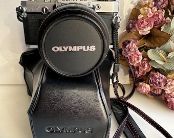 Vintage SLR camera Olympus OM-10 with Zuiko 1:4 35-70 mm lens