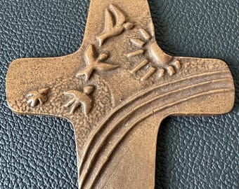 A wall cross commemorating the First Communion, a relief cross