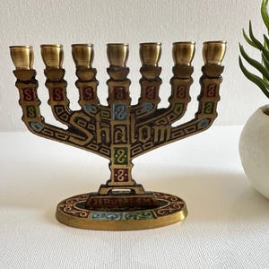 Vintage brass mini Menorah for 7 candles.
