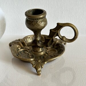 Vintage bronze candlestick with Scottish thistle and handle, decorative