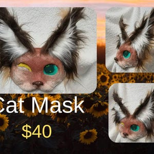 May include: A cat mask with brown, white, and black fur, and large, expressive eyes. The mask has a winking eye with a yellow accent and a green eye. The text "Cat Mask" is displayed in white.