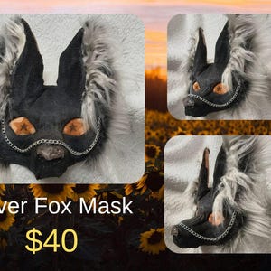 May include: A silver fox mask with black ears and face, orange eyes, and a silver chain. The mask is surrounded by fluffy, gray fur. The text "Silver Fox Mask" is visible.