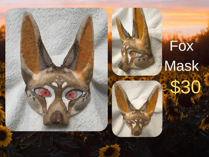 May include: A fox mask with a watercolor design. The mask features a brown and tan color scheme with orange ears and red eyes. The text "Fox Mask" is visible in the image.