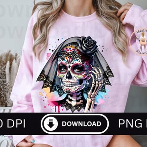 May include: A light pink sweatshirt featuring a colorful sugar skull design with a black veil and rose. The image includes the text "300 DPI DOWNLOAD PNG FILE". The design is a digital download.