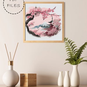May include: Cross stitch pattern featuring a Japanese landscape with a mountain, cherry blossoms, and a pagoda. The pattern is in a circular frame and is ready for instant download.