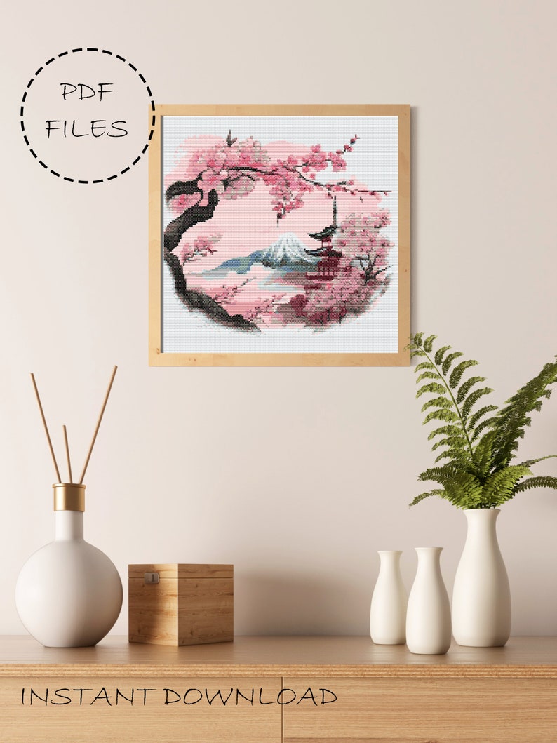May include: Cross stitch pattern featuring a Japanese landscape with a mountain, cherry blossoms, and a pagoda. The pattern is in a circular frame and is ready for instant download.
