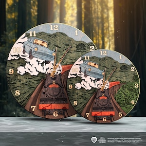 May include: Wooden wall clock featuring a blue car and a train on a track, with a green mountain backdrop. The clock has gold-colored hands and numbers. The clock face has the text "Hogwarts Express 5972".