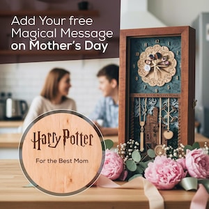 May include: A wooden clock with a Harry Potter theme, featuring a detailed laser-cut design and the text "It's not a clock, but it's home." The clock is displayed with pink flowers and the text "Add Your free Magical Message on Mother's Day."