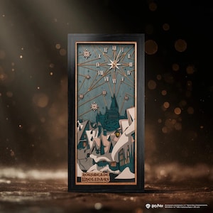 May include: A rectangular wall clock with a black frame featuring a layered wooden scene of a snow-covered village and a castle. The clock face displays Roman numerals, a starburst design, and snowflake accents. The text Hogsmeade Holidays is visible.