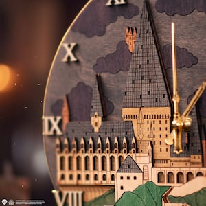 May include: A wooden clock featuring a detailed illustration of Hogwarts Castle, with Roman numeral hour markers. The clock face is dark brown with a black and white illustration of the castle. The clock hands are gold.