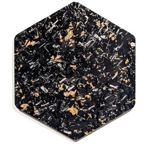 May include: Black hexagonal wall art with a textured surface and gold flecks throughout.