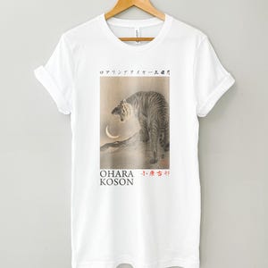 May include: White t-shirt with a black and white image of a tiger roaring at a crescent moon. The text "OHARA KOSON" and Japanese characters are printed below the image.