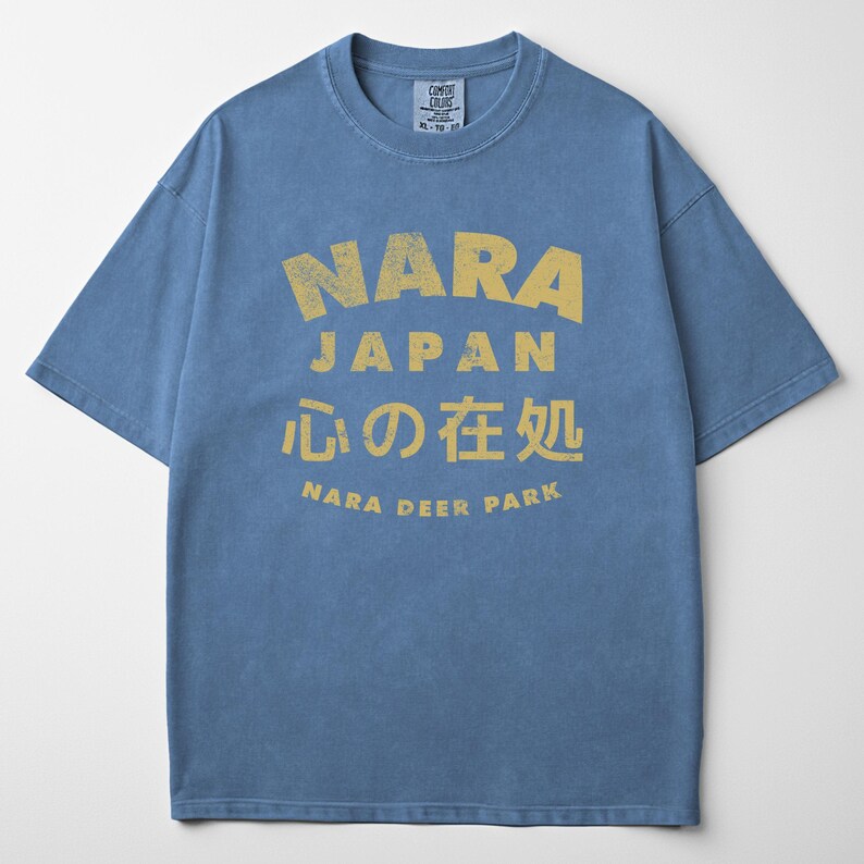 May include: Blue t-shirt with a yellow graphic that says "NARA JAPAN" in large letters, with Japanese characters and "NARA DEER PARK" below. The shirt is a Comfort Colors brand, size XL-TG-XG.