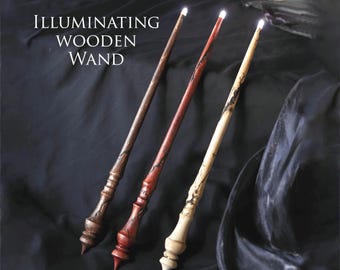 May include: Three wooden wands with glowing tips. The wands are different colors: brown, red, and white. The text "ILLUMINATING WOODEN WAND" is at the top of the image.