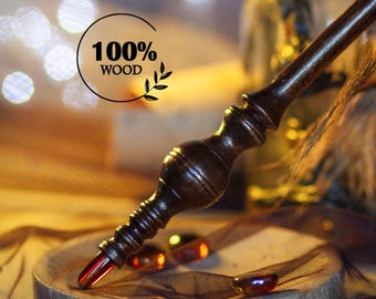 May include: A dark brown wooden wand with intricate carvings and a red crystal tip. The wand is labeled "100% WOOD" and is set against a blurred background with warm lighting. The wand is a magical item.
