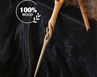 May include: A light-colored wooden wand with a carved spiral design and a circular opening at the top. The text "100% WOOD" is in a white circle. The wand is displayed on a dark, textured surface.