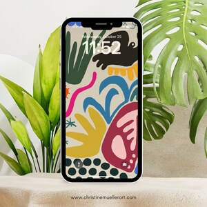 Puede incluir: Un fondo de pantalla de tel&eacute;fono abstracto colorido con un fondo beige. El fondo de pantalla presenta una variedad de formas y colores, incluyendo verde, azul, amarillo, rosa y rojo. La hora se muestra en la pantalla del tel&eacute;fono como 11:52.