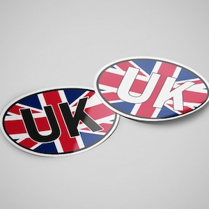 May include: Two oval stickers with the text "UK" printed in white and black letters on a red, white and blue Union Jack flag background.