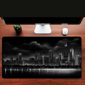 May include: Black and white illustration of a city skyline at night. The city is reflected in the water below. The skyline is made up of tall buildings, including skyscrapers. The sky is dark and cloudy.